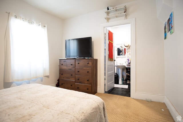 carpeted bedroom with multiple windows and sink