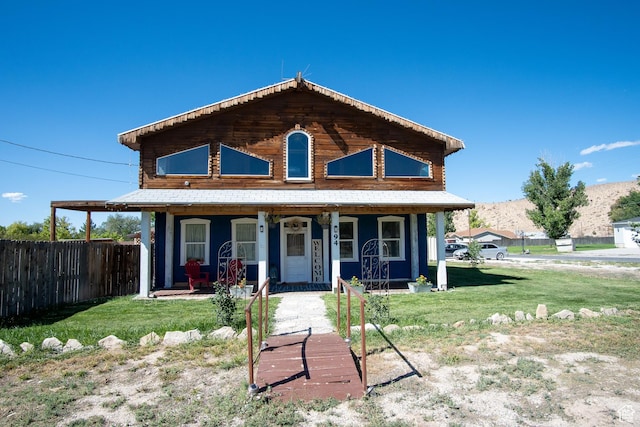 view of front facade with covered porch and a front yard