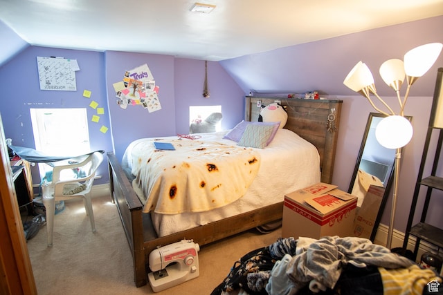 bedroom with carpet flooring and vaulted ceiling