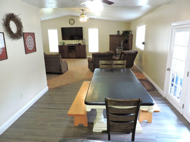 325 N 100 W, Delta, UT 84624 - dining space featuring baseboards, ceiling fan, wood finished floors, a wood stove, and vaulted ceiling