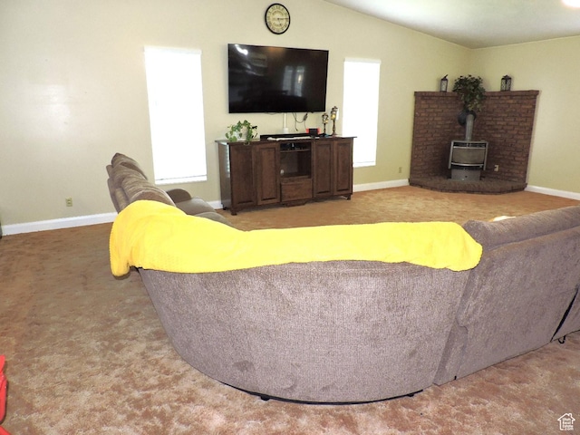 325 N 100 W, Delta, UT 84624 - carpeted living room with baseboards, lofted ceiling, a wood stove, and a healthy amount of sunlight