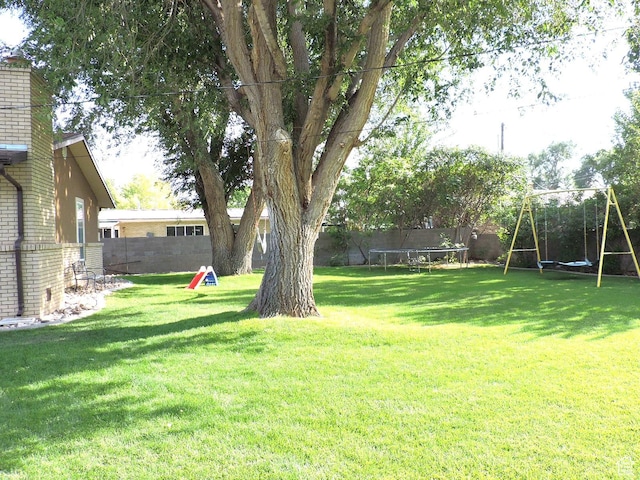 325 N 100 W, Delta, UT 84624 - view of yard featuring a trampoline, a playground, and a fenced backyard