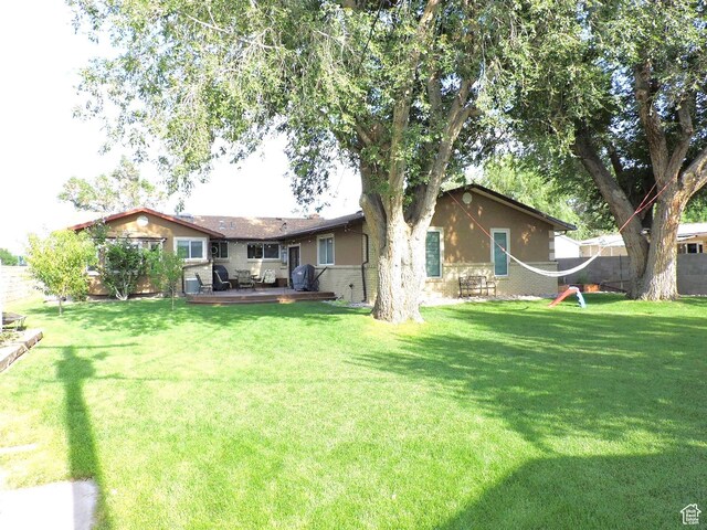 325 N 100 W, Delta, UT 84624 - rear view of house featuring fence, a deck, and a yard