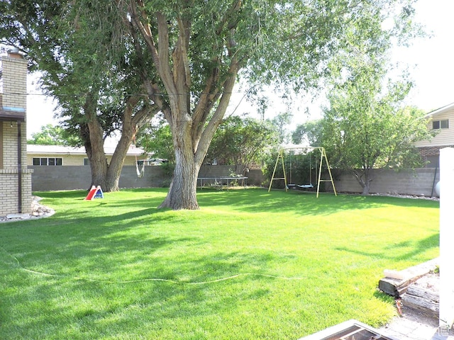 325 N 100 W, Delta, UT 84624 - view of yard featuring a trampoline, a playground, and a fenced backyard