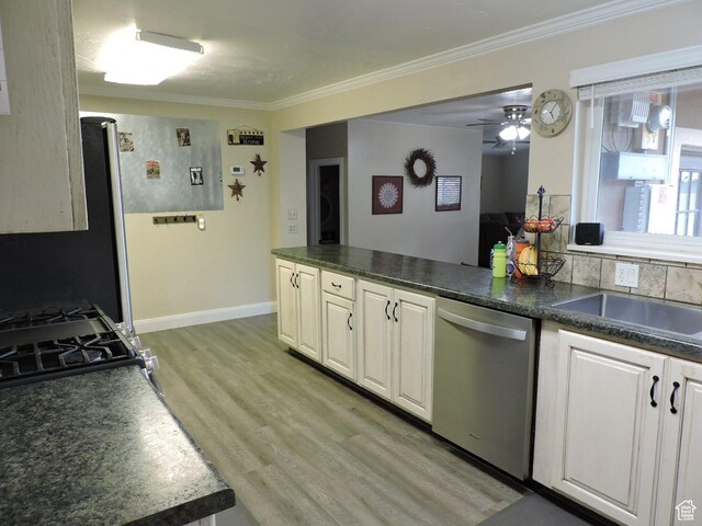 325 N 100 W, Delta, UT 84624 - kitchen with ornamental molding, dark countertops, stainless steel dishwasher, and light wood-type flooring