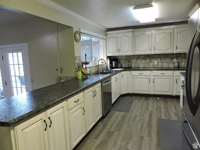 325 N 100 W, Delta, UT 84624 - kitchen with ornamental molding, decorative backsplash, dark countertops, a peninsula, and appliances with stainless steel finishes