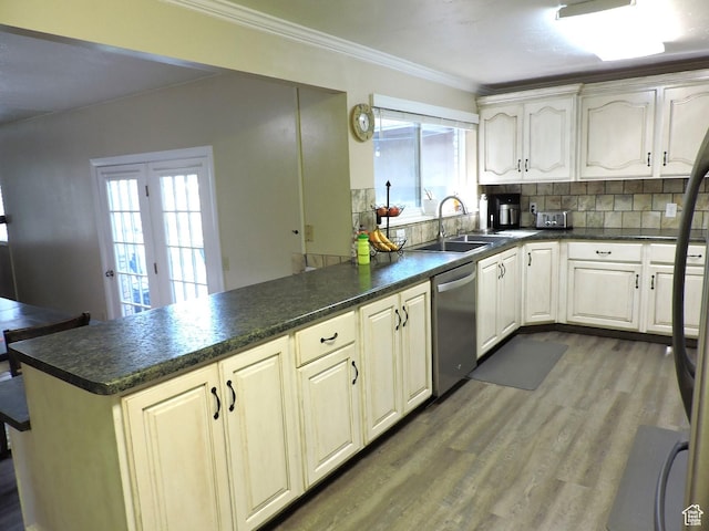 325 N 100 W, Delta, UT 84624 - kitchen with a peninsula, ornamental molding, tasteful backsplash, dark wood-style floors, and stainless steel dishwasher