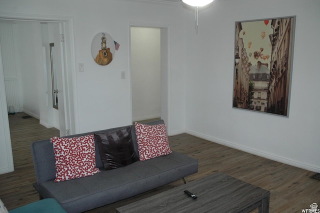 living area featuring baseboards and wood finished floors