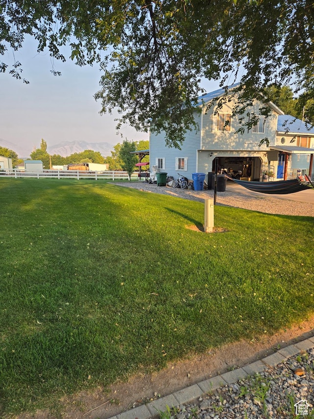 136 S 200 W, Wellsville, UT 84339 - view of yard featuring an attached garage, a mountain view, and driveway