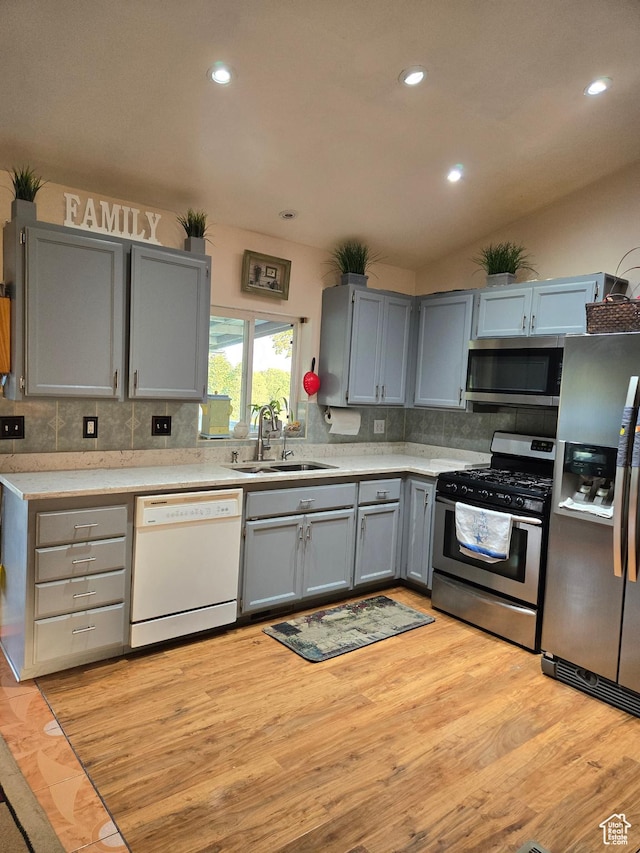 136 S 200 W, Wellsville, UT 84339 - kitchen with stainless steel appliances, a sink, gray cabinets, tasteful backsplash, and light countertops