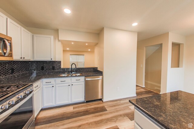 1279 W Culloden Ct, Murray, UT 84123 - kitchen with a sink, light wood-style floors, appliances with stainless steel finishes, tasteful backsplash, and dark stone countertops