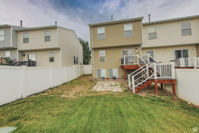 1279 W Culloden Ct, Murray, UT 84123 - rear view of house featuring stairs, a lawn, a wooden deck, and fence