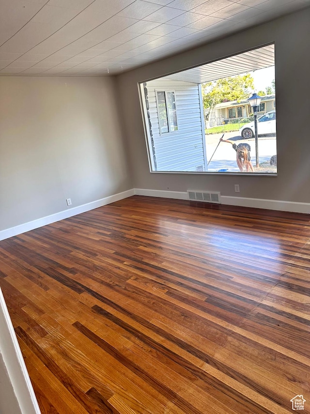 3164 W Mark Ave S, West Valley City, UT 84119 - unfurnished room with dark wood-style flooring, baseboards, and visible vents