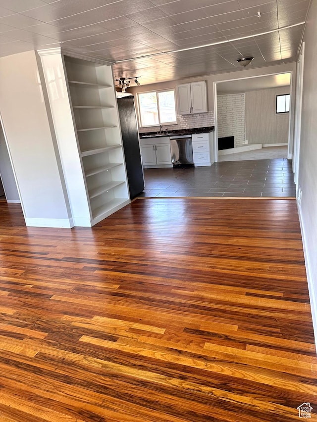 3164 W Mark Ave S, West Valley City, UT 84119 - kitchen featuring open floor plan, stainless steel dishwasher, dark countertops, and dark wood-style flooring
