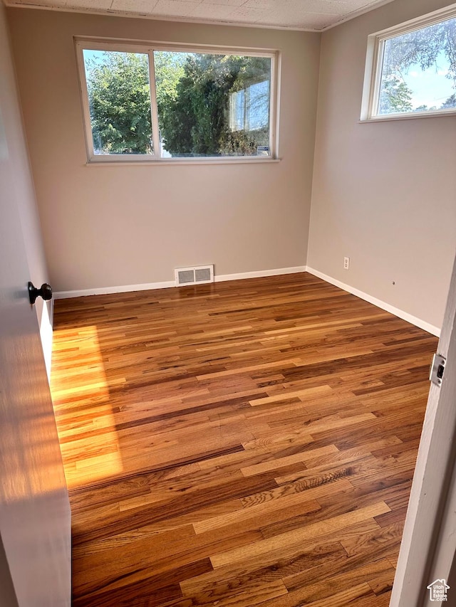 3164 W Mark Ave S, West Valley City, UT 84119 - unfurnished room featuring wood finished floors, baseboards, and visible vents
