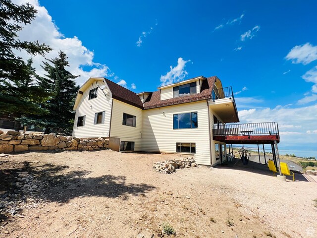 588 W Raspberry Patch Rd, Garden City, UT 84028 - back of property featuring driveway, a balcony, a gambrel roof, and roof with shingles
