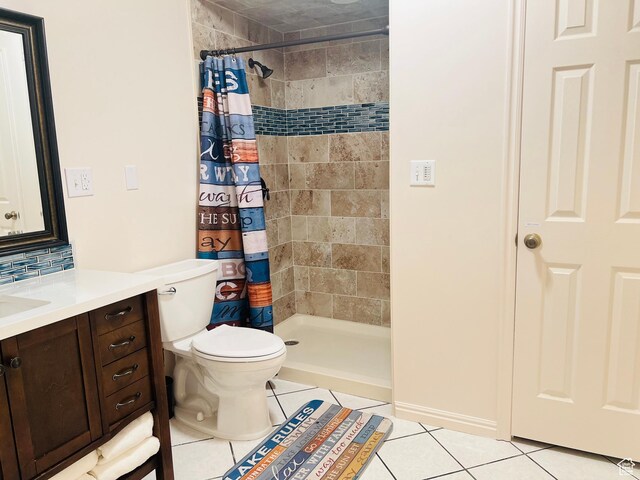 588 W Raspberry Patch Rd, Garden City, UT 84028 - bathroom with tile patterned flooring, toilet, a tile shower, and vanity