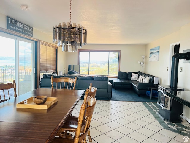 588 W Raspberry Patch Rd, Garden City, UT 84028 - dining space featuring light tile patterned floors, a chandelier, and a wood stove