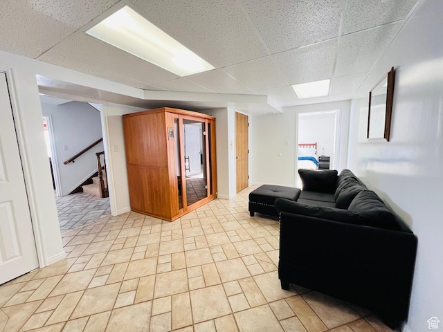 588 W Raspberry Patch Rd, Garden City, UT 84028 - living room featuring baseboards, a paneled ceiling, and stairs