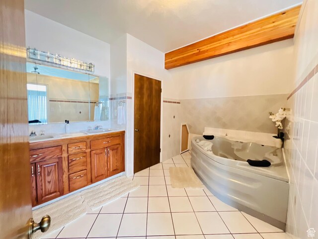 588 W Raspberry Patch Rd, Garden City, UT 84028 - full bath with tile patterned flooring, tile walls, a whirlpool tub, and a sink