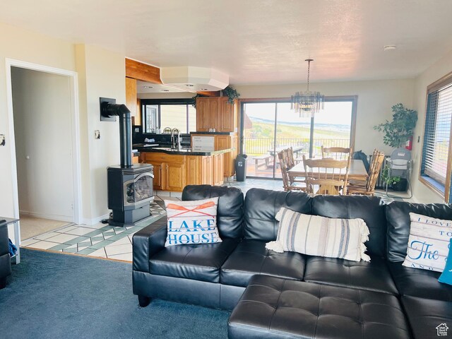 588 W Raspberry Patch Rd, Garden City, UT 84028 - living area featuring an inviting chandelier, light tile patterned floors, baseboards, light colored carpet, and a wood stove