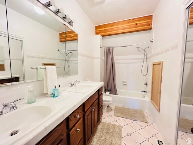 588 W Raspberry Patch Rd, Garden City, UT 84028 - bathroom featuring a sink, toilet, tile walls, and shower / bath combo