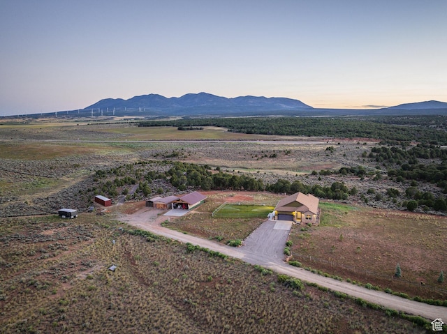 aerial view at dusk featuring a rural view and a mountain view