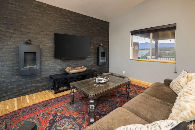 living room featuring lofted ceiling and wood finished floors