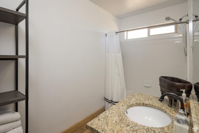 bathroom with vanity, a shower with shower curtain, and wood finished floors