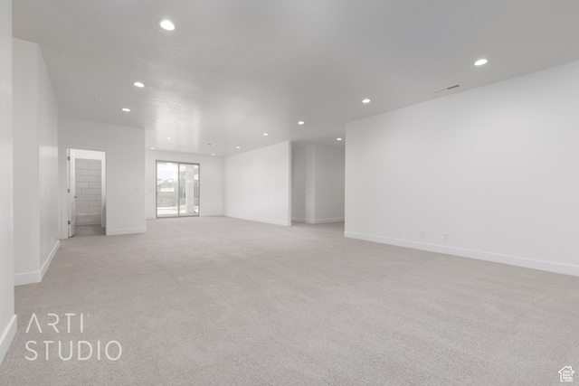 unfurnished room with light carpet