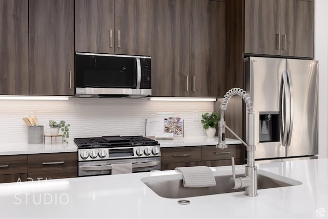 445 N 250 E, La Verkin, UT 84745 - kitchen featuring appliances with stainless steel finishes, dark brown cabinets, light countertops, and decorative backsplash