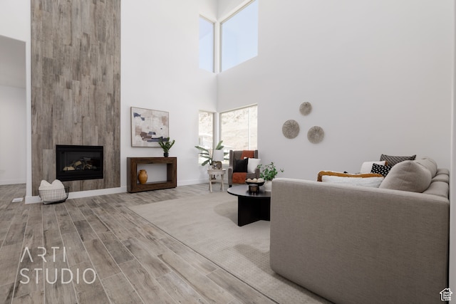 living room with a towering ceiling and hardwood / wood-style floors