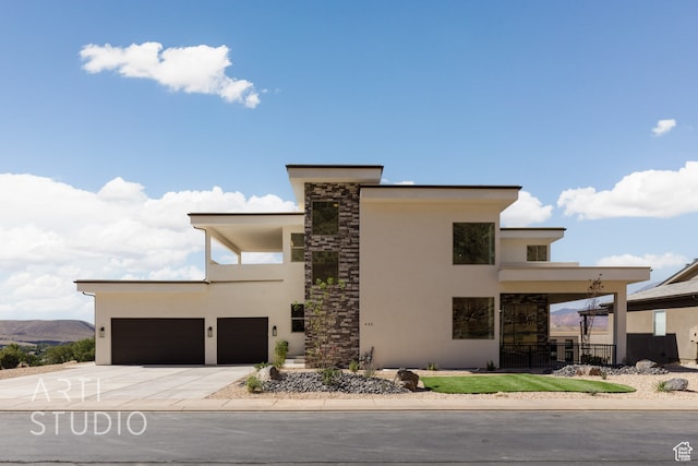 contemporary house with a mountain view and a garage