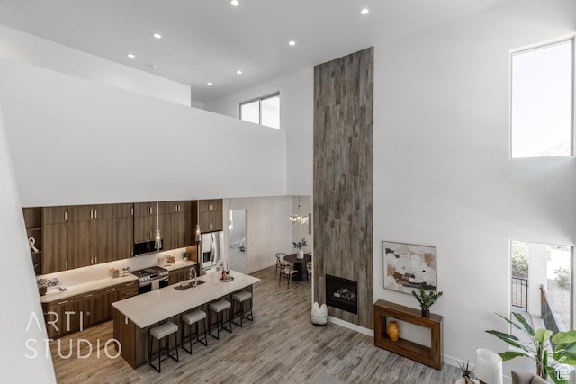 445 N 250 E, La Verkin, UT 84745 - living room with a towering ceiling, recessed lighting, light wood-style flooring, a chandelier, and baseboards