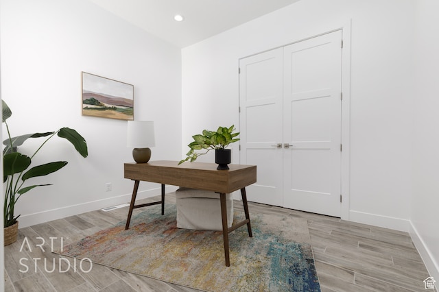 office with light hardwood / wood-style flooring