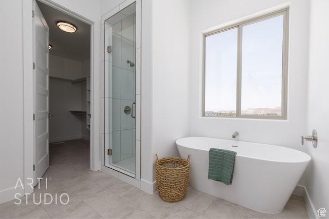 bathroom featuring plus walk in shower and tile patterned floors