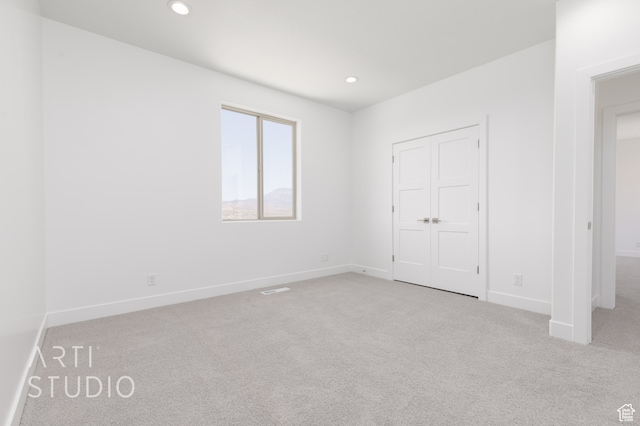 unfurnished bedroom featuring light colored carpet