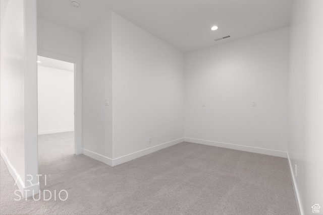 empty room featuring light colored carpet