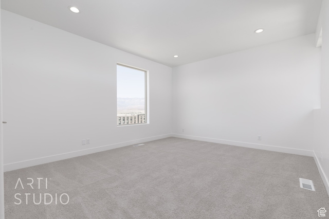 spare room with light carpet