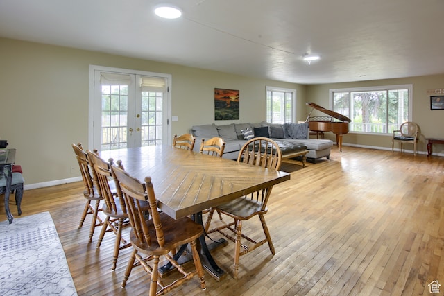 dining area with french doors and light wood-type flooring