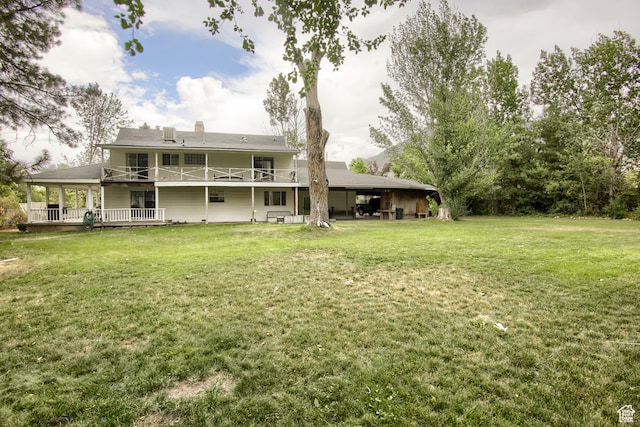 back of property featuring a lawn