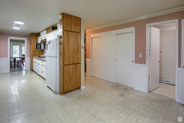 kitchen featuring light tile patterned floors, gas cooktop, and white refrigerator