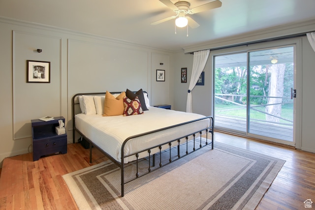 bedroom featuring access to outside, light wood-type flooring, crown molding, and ceiling fan