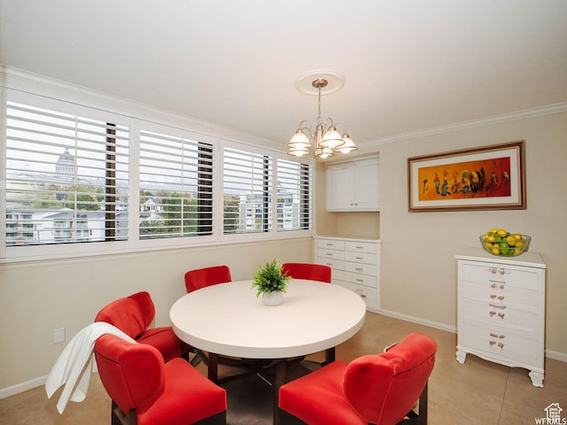 dining room featuring a chandelier, crown molding, and baseboards