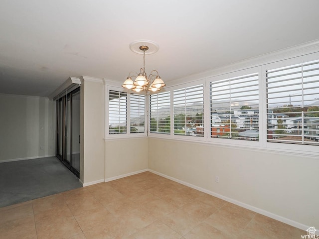 unfurnished room featuring a chandelier, light tile patterned floors, and baseboards