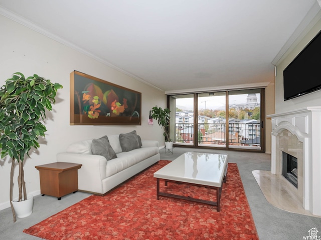 living room with baseboards, ornamental molding, carpet floors, floor to ceiling windows, and a high end fireplace