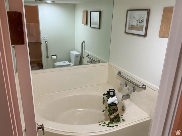 full bath featuring toilet and a garden tub