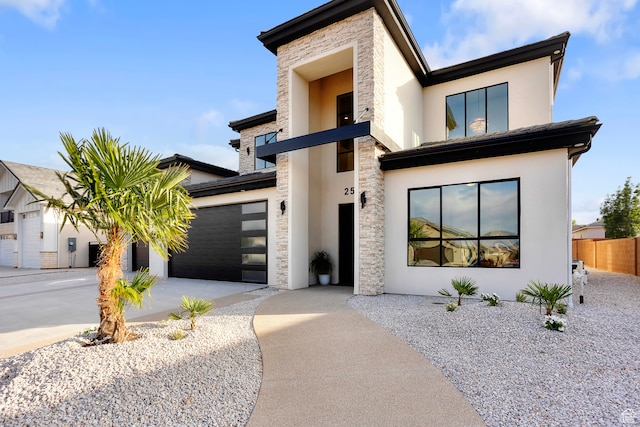 2596 S Gritton St, Hurricane, UT 84737 - contemporary house featuring stone siding, stucco siding, an attached garage, and concrete driveway