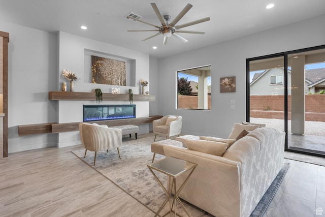 2596 S Gritton St, Hurricane, UT 84737 - living area with visible vents, baseboards, ceiling fan, recessed lighting, and a glass covered fireplace