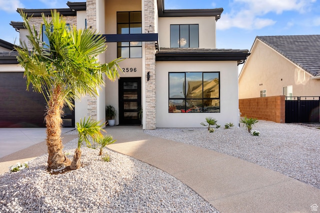 2596 S Gritton St, Hurricane, UT 84737 - modern home with stone siding, stucco siding, and fence